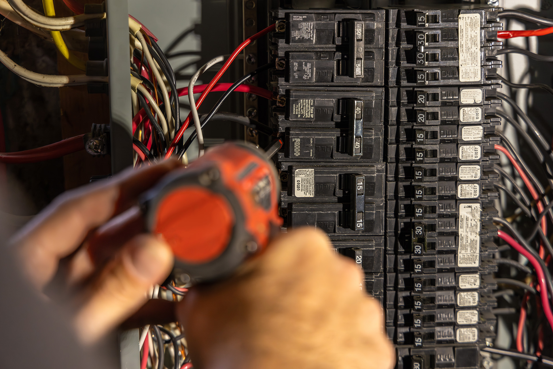 Electrician installing a circuit panel